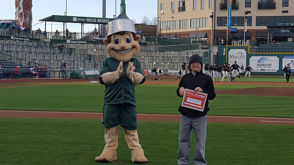 Kevin displays his award with the Tincaps Mascot